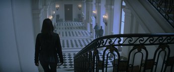 Movie still from “The Hunger Games: Mockingjay - Part 2” (2015), directed by Francis Lawrence – People are walking down the stairs of a large building; Wide shot, High angle