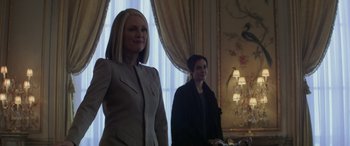 Movie still from “The Hunger Games: Mockingjay - Part 2” (2015), directed by Francis Lawrence – Two women standing next to each other in front of a window; Medium shot, Low angle