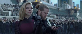 Movie still from “The Hunger Games: Mockingjay - Part 2” (2015), directed by Francis Lawrence – A man and a woman are looking at a cell phone; Close Up shot, Low angle