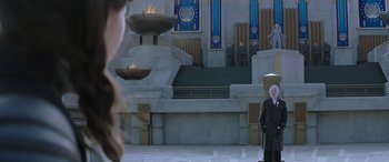 Movie still from “The Hunger Games: Mockingjay - Part 2” (2015), directed by Francis Lawrence – A man standing in front of a fire pit; Wide shot, High angle