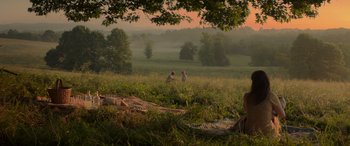 Movie still from “The Hunger Games: Mockingjay - Part 2” (2015), directed by Francis Lawrence – A couple of people in a grassy field; Extreme Wide shot, High angle