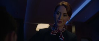 Movie still from “The Hunt” (2020), directed by Craig Zobel – A woman wearing a black jacket and a red and white neck tie; Close Up shot, Low angle