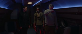 Movie still from “The Hunt” (2020), directed by Craig Zobel – A group of men standing next to each other in a room; Medium shot, Low angle