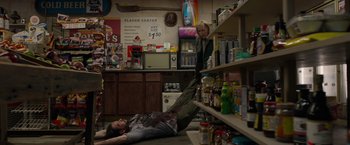 Movie still from “The Hunt” (2020), directed by Craig Zobel – Two people are laying on the floor in a store; Wide shot, High angle