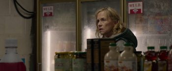 Movie still from “The Hunt” (2020), directed by Craig Zobel – An older woman looking out of a kitchen window; Close Up shot, Over the shoulder angle