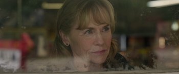 Movie still from “The Hunt” (2020), directed by Craig Zobel – A person looking out a window; Close Up shot, Over the shoulder angle