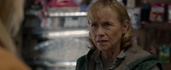 Movie still from “The Hunt” (2020), directed by Craig Zobel – An older woman is looking at the camera; Close Up shot, Over the shoulder angle