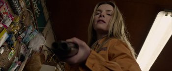 Movie still from “The Hunt” (2020), directed by Craig Zobel – A woman in an orange jacket holding a gun; Close Up shot, Low angle