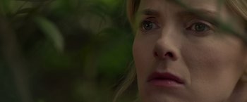 Movie still from “The Hunt” (2020), directed by Craig Zobel – A woman's face in front of trees; Extreme Close Up shot, Over the shoulder angle