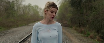 Movie still from “The Hunt” (2020), directed by Craig Zobel – A young woman with blood all over her face; Medium shot, Over the shoulder angle