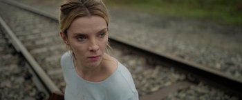 Movie still from “The Hunt” (2020), directed by Craig Zobel – A person near a rail road track; Close Up shot, Over the shoulder angle