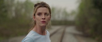 Movie still from “The Hunt” (2020), directed by Craig Zobel – A woman standing in front of train tracks; Close Up shot, Low angle