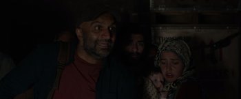 Movie still from “The Hunt” (2020), directed by Craig Zobel – A group of people standing next to each other in the dark; Close Up shot, Over the shoulder angle