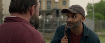 Movie still from “The Hunt” (2020), directed by Craig Zobel – A man with a beard talking to another man wearing a hat; Close Up shot, Over the shoulder angle