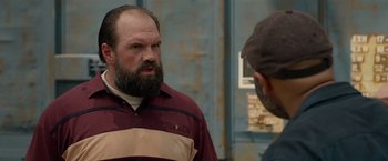 Movie still from “The Hunt” (2020), directed by Craig Zobel – A man with a goatee talking to another man; Close Up shot, Over the shoulder angle