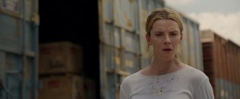 Movie still from “The Hunt” (2020), directed by Craig Zobel – A woman standing in front of a building; Close Up shot, Low angle