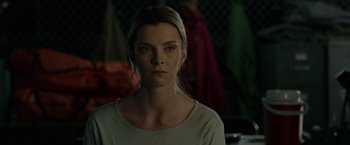 Movie still from “The Hunt” (2020), directed by Craig Zobel – A woman in a white shirt is looking at the camera; Close Up shot, Over the shoulder angle