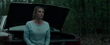 Movie still from “The Hunt” (2020), directed by Craig Zobel – A woman standing in front of an open trunk of a car; Medium shot, Low angle