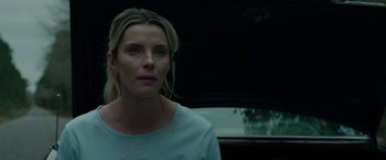 Movie still from “The Hunt” (2020), directed by Craig Zobel – A woman standing in front of a black car; Close Up shot, Low angle