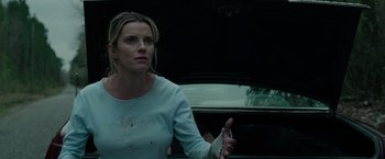 Movie still from “The Hunt” (2020), directed by Craig Zobel – A woman in a white shirt in a black car; Medium shot, Low angle