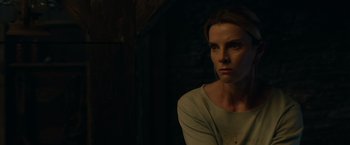 Movie still from “The Hunt” (2020), directed by Craig Zobel – A woman in a white shirt is in a dark room; Close Up shot, Low angle