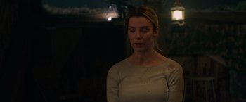 Movie still from “The Hunt” (2020), directed by Craig Zobel – A beautiful woman with a bruised face looking at the camera; Close Up shot, Over the shoulder angle