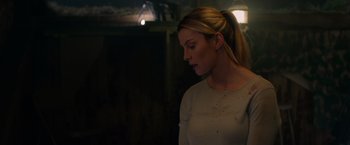 Movie still from “The Hunt” (2020), directed by Craig Zobel – A beautiful blonde haired woman in a white shirt; Close Up shot, Over the shoulder angle