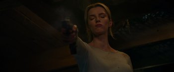 Movie still from “The Hunt” (2020), directed by Craig Zobel – A woman holding a gun in a dark room; Close Up shot, Low angle