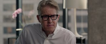 Movie still from “The Hunt” (2020), directed by Craig Zobel – A person wearing a white shirt and glasses; Close Up shot, Over the shoulder angle