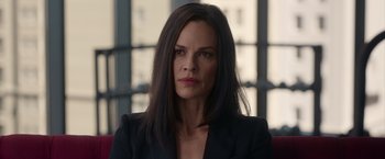 Movie still from “The Hunt” (2020), directed by Craig Zobel – A person wearing a suit; Close Up shot, Over the shoulder angle