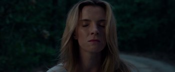 Movie still from “The Hunt” (2020), directed by Craig Zobel – A woman with long blonde hair is looking down; Close Up shot, Low angle