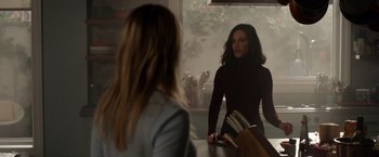 Movie still from “The Hunt” (2020), directed by Craig Zobel – A woman standing in front of a mirror looking at another woman; Medium shot, Over the shoulder angle