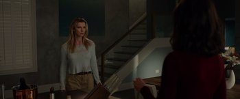 Movie still from “The Hunt” (2020), directed by Craig Zobel – A woman standing in front of a mirror in front of a staircase; Medium shot, Over the shoulder angle