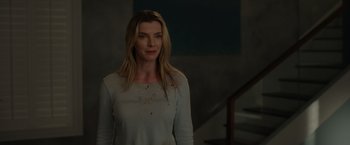 Movie still from “The Hunt” (2020), directed by Craig Zobel – A woman standing in front of a railing with blood all over her face; Medium shot, Over the shoulder angle