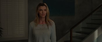 Movie still from “The Hunt” (2020), directed by Craig Zobel – A woman standing in front of a staircase with blood on her shirt; Medium shot, Over the shoulder angle