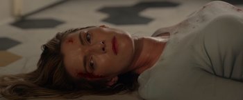 Movie still from “The Hunt” (2020), directed by Craig Zobel – A person laying on the ground with blood on their face; Close Up shot, Overhead angle