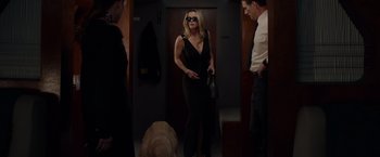 Movie still from “The Hunt” (2020), directed by Craig Zobel – A woman in a black dress and sunglasses standing next to a brown dog; Wide shot, Low angle