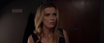 Movie still from “The Hunt” (2020), directed by Craig Zobel – A woman with long blonde hair wearing a black top; Close Up shot, Over the shoulder angle