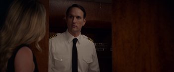 Movie still from “The Hunt” (2020), directed by Craig Zobel – A man wearing a white shirt and a black tie; Close Up shot, Low angle