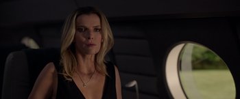 Movie still from “The Hunt” (2020), directed by Craig Zobel – A woman in a black top is looking at a mirror; Close Up shot, Over the shoulder angle