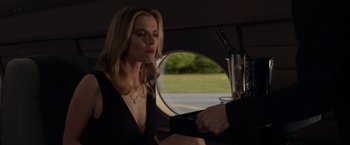 Movie still from “The Hunt” (2020), directed by Craig Zobel – A woman sitting in a car with a glass of wine; Medium shot, Over the shoulder angle