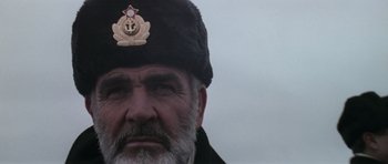 Movie still from “The Hunt for Red October” (1990), directed by John McTiernan – An old man with a beard wearing a black hat; Close Up shot, Low angle