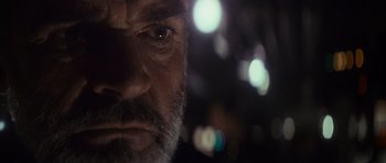Movie still from “The Hunt for Red October” (1990), directed by John McTiernan – A man's face with lights in the background; Extreme Close Up shot, Low angle