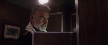 Movie still from “The Hunt for Red October” (1990), directed by John McTiernan – An older man looking at himself in a mirror; Close Up shot, Low angle