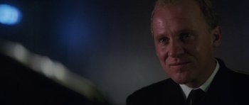 Movie still from “The Hunt for Red October” (1990), directed by John McTiernan – A person wearing a black shirt; Close Up shot, Over the shoulder angle