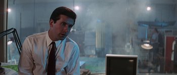 Movie still from “The Hunt for Red October” (1990), directed by John McTiernan – A man sitting in front of a computer monitor; Medium shot, Over the shoulder angle