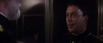 Movie still from “The Hunt for Red October” (1990), directed by John McTiernan – A man in a uniform standing in front of a door; Close Up shot, Over the shoulder angle