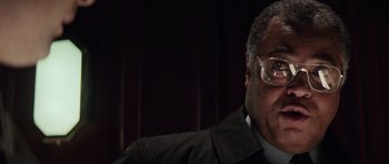 Movie still from “The Hunt for Red October” (1990), directed by John McTiernan – An older man wearing glasses and a black jacket; Close Up shot, Low angle