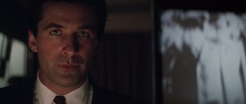 Movie still from “The Hunt for Red October” (1990), directed by John McTiernan – A person wearing a suit and tie; Close Up shot, Low angle