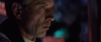 Movie still from “The Hunt for Red October” (1990), directed by John McTiernan – A man's face in front of a blurry background; Close Up shot, Low angle